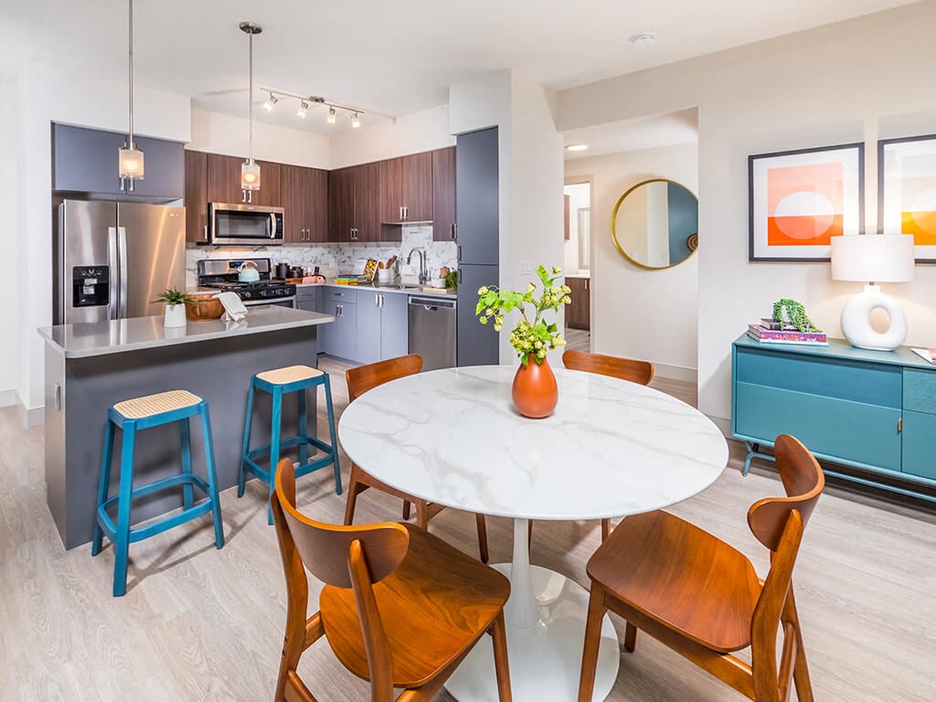 A dining table overlooking the kitchen at the Embark Apartments in Fremont, California.